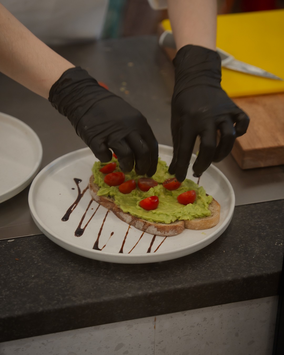 Plating smashed avocado on sourdough